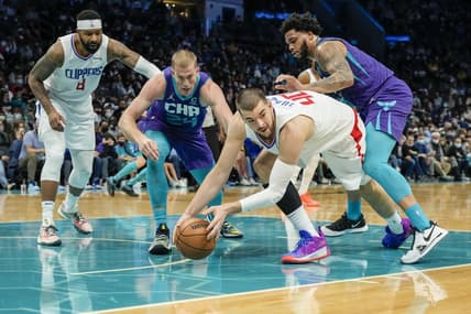 Jan 30, 2022; Charlotte, North Carolina, USA; LA Clippers center Ivica Zubac (40) tries to pass a loose ball off to a teammate chased by Charlotte Hornets center Mason Plumlee (24) and forward Miles Bridges (0) during the second quarter at the Spectrum Center. Mandatory Credit: Jim Dedmon-USA TODAY Sports