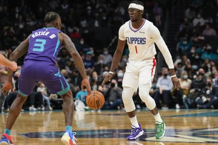 Jan 30, 2022; Charlotte, North Carolina, USA; LA Clippers guard Reggie Jackson (1) on the dribble covered by Charlotte Hornets guard Terry Rozier (3) during the second half at the Spectrum Center. Mandatory Credit: Jim Dedmon-USA TODAY Sports