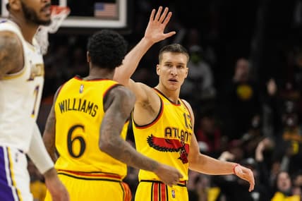 Jan 30, 2022; Atlanta, Georgia, USA; Atlanta Hawks guard Lou Williams (6) reacts with guard Bogdan Bogdanovic (13) after making a basket against the Los Angeles Lakers during the second half at State Farm Arena. Mandatory Credit: Dale Zanine-USA TODAY Sports