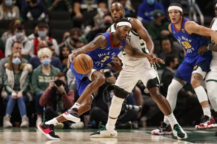Jan 30, 2022; Milwaukee, Wisconsin, USA;  Denver Nuggets guard Will Barton (5) drives to the basket against Milwaukee Bucks forward Khris Middleton (22) during the first quarter at Fiserv Forum. Mandatory Credit: Jeff Hanisch-USA TODAY Sports