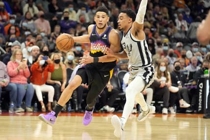 Jan 30, 2022; Phoenix, Arizona, USA; Phoenix Suns guard Devin Booker (1) controls the ball defended by San Antonio Spurs forward Zach Collins (23) in the first half at Footprint Center. Mandatory Credit: Rick Scuteri-USA TODAY Sports