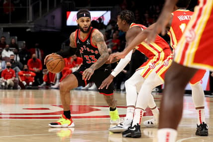Jan 31, 2022; Atlanta, Georgia, USA; Toronto Raptors guard Gary Trent Jr. (33) drives against Atlanta Hawks guard Delon Wright (0) during the first quarter at State Farm Arena. Mandatory Credit: Jason Getz-USA TODAY Sports