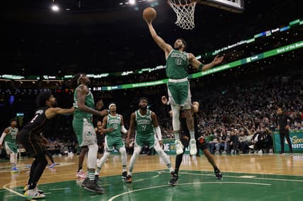 Jan 31, 2022; Boston, Massachusetts, USA; Boston Celtics forward Jayson Tatum (0) grabs a rebound against the Miami Heat during the second quarter at TD Garden. Mandatory Credit: Winslow Townson-USA TODAY Sports