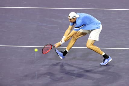 American John Isner returns a shot to Yoshihito Nishioka of Japan during the BNP Paribas Open in Indian Wells, Calif., on October 10, 2021.

John Isner Vs Yoshihito Nishioka Bnp Paribas2073