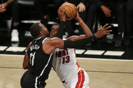 Oct 27, 2021; Brooklyn, New York, USA; Miami Heat center Bam Adebayo (13) is fouled by Brooklyn Nets forward Paul Millsap (31) during the fourth quarter at Barclays Center. Mandatory Credit: Brad Penner-USA TODAY Sports