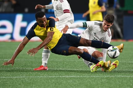 Oct 27, 2021; Charlotte, North Carolina, USA;  Ecuador forward Michael Estrada (11) and Mexico defender Haret Ortaga (13) fight for the ball in the second half at Bank of America Stadium. Mandatory Credit: Bob Donnan-USA TODAY Sports
