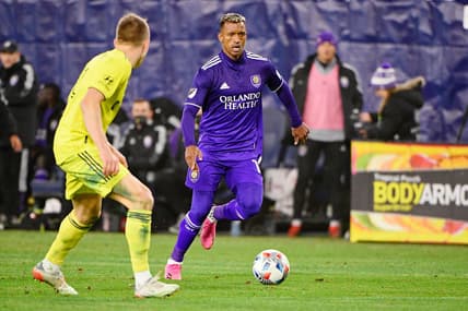 Nov 23, 2021; Nashville, TN, USA; Orlando City forward Benji Michel (19) dribbles the ball around Nashville SC defender Alistair Johnston (12) during the second half of a round one MLS Playoff game at Nissan Stadium. Mandatory Credit: Steve Roberts-USA TODAY Sports