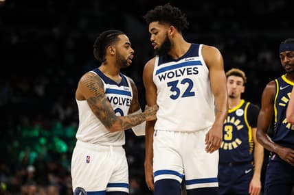 Nov 29, 2021; Minneapolis, Minnesota, USA; Minnesota Timberwolves guard D'Angelo Russell (0) talks to center Karl-Anthony Towns (32) in the first quarter against the Indiana Pacers in the first quarter at Target Center. Mandatory Credit: David Berding-USA TODAY Sports