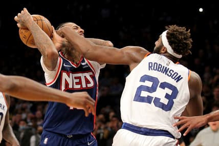 Nov 30, 2021; Brooklyn, New York, USA; Brooklyn Nets forward James Johnson (16) is fouled as he drives to the basket by New York Knicks center Mitchell Robinson (23) during the fourth quarter at Barclays Center. Mandatory Credit: Brad Penner-USA TODAY Sports