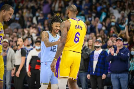 Dec 29, 2021; Memphis, Tennessee, USA; Memphis Grizzlies guard Ja Morant (12) hugs Los Angeles Lakers forward LeBron James (6) after the game at the FedExForum. Mandatory Credit: Jerome Miron-USA TODAY Sports