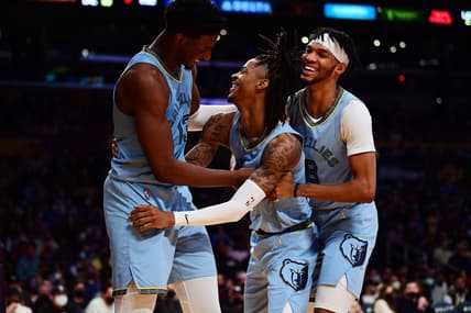 Jan 9, 2022; Los Angeles, California, USA; Memphis Grizzlies guard Ja Morant (12) reacts with forward Jaren Jackson Jr. (13) and guard Ziaire Williams (8) after scoring a basket and drawing the foul against the Los Angeles Lakers during the second half at Crypto.com Arena. Mandatory Credit: Gary A. Vasquez-USA TODAY Sports