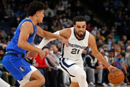 Jan 14, 2022; Memphis, Tennessee, USA; Memphis Grizzles guard Tyus Jones (21) dribbles as Dallas Mavericks guard Josh Green (8) defends during the first half at FedExForum. Mandatory Credit: Petre Thomas-USA TODAY Sports