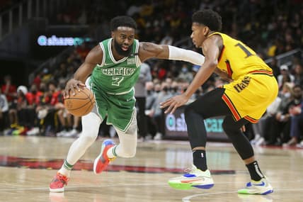 Jan 28, 2022; Atlanta, Georgia, USA; Boston Celtics guard Jaylen Brown (7) drives on Atlanta Hawks forward De'Andre Hunter (12) in the second half at State Farm Arena. Mandatory Credit: Brett Davis-USA TODAY Sports