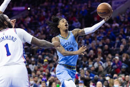 Jan 31, 2022; Philadelphia, Pennsylvania, USA; Memphis Grizzlies guard Ja Morant (12) drives for a shot past Philadelphia 76ers center Andre Drummond (1) during the third quarter at Wells Fargo Center. Mandatory Credit: Bill Streicher-USA TODAY Sports