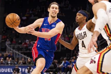 Feb 1, 2022; Detroit, Michigan, USA; Detroit Pistons forward Kelly Olynyk (13) passes the ball as he is defended by New Orleans Pelicans guard Devonte' Graham (4) during the second quarter at Little Caesars Arena. Mandatory Credit: Raj Mehta-USA TODAY Sports