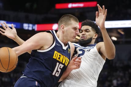 Feb 1, 2022; Minneapolis, Minnesota, USA; Minnesota Timberwolves center Karl-Anthony Towns (32) fouls Denver Nuggets center Nikola Jokic (15) as he drives to the basket in the second quarter at Target Center. Mandatory Credit: Bruce Kluckhohn-USA TODAY Sports