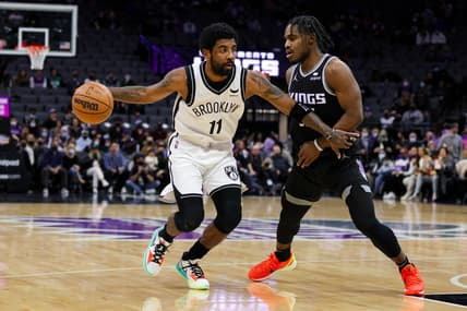Feb 2, 2022; Sacramento, California, USA; Brooklyn Nets guard Kyrie Irving (11) controls the ball against Sacramento Kings guard Davion Mitchell (15) during the first quarter at Golden 1 Center. Mandatory Credit: Sergio Estrada-USA TODAY Sports