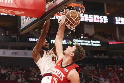 Feb 2, 2022; Houston, Texas, USA;  Cleveland Cavaliers center Evan Mobley (4) dunks against Houston Rockets center Alperen Sengun (28) in the second half at Toyota Center. Mandatory Credit: Thomas Shea-USA TODAY Sports
