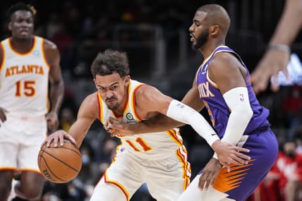 Feb 3, 2022; Atlanta, Georgia, USA; Phoenix Suns guard Chris Paul (3) tries to defend Atlanta Hawks guard Trae Young (11) during the first half at State Farm Arena. Mandatory Credit: Dale Zanine-USA TODAY Sports