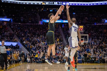 Feb 3, 2022; San Francisco, California, USA; Golden State Warriors guard Klay Thompson (11) shoots a three point basket during the fourth quarter against Sacramento Kings guard Davion Mitchell (15) at Chase Center. Mandatory Credit: Neville E. Guard-USA TODAY Sports