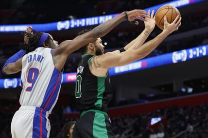 Feb 4, 2022; Detroit, Michigan, USA;  Boston Celtics forward Jayson Tatum (0) goes to the basket on Detroit Pistons forward Jerami Grant (9) in the first half at Little Caesars Arena. Mandatory Credit: Rick Osentoski-USA TODAY Sports