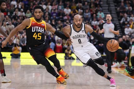 Feb 4, 2022; Salt Lake City, Utah, USA;  Brooklyn Nets guard Jevon Carter (0) drives the ball against Utah Jazz guard Donovan Mitchell (45) in the second quarter at Vivint Arena. Mandatory Credit: Rob Gray-USA TODAY Sports