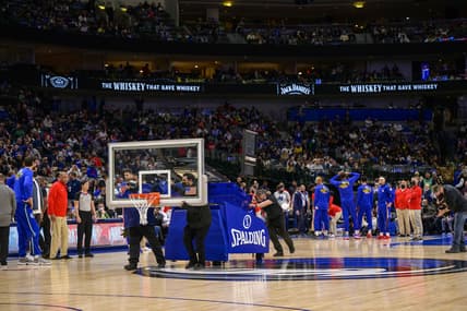 Feb 4, 2022; Dallas, Texas, USA; The American Airlines Center arena crew roll out a secondary backup backboard during the first quarter of the game between the Dallas Mavericks and the Philadelphia 76ers at the American Airlines Center. Mandatory Credit: Jerome Miron-USA TODAY Sports