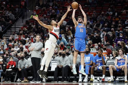 Feb 4, 2022; Portland, Oregon, USA; Oklahoma City Thunder shooting guard Ty Jerome (16) shoots the ball over Portland Trail Blazers shooting guard CJ McCollum (3) during the first half at Moda Center. Mandatory Credit: Soobum Im-USA TODAY Sports