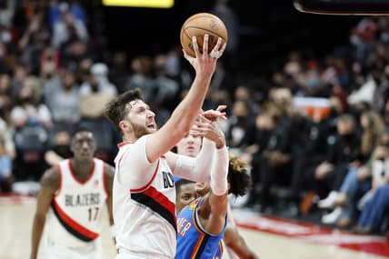 Feb 4, 2022; Portland, Oregon, USA; Portland Trail Blazers Center Jusuf Nurkic (27, left) shoots the ball against Oklahoma City Thunder point guard Tre Mann (23) during the second half at Moda Center. Mandatory Credit: Soobum Im-USA TODAY Sports