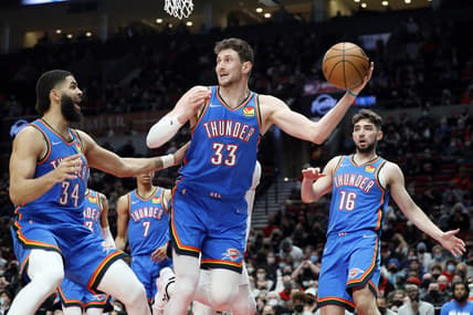 Feb 4, 2022; Portland, Oregon, USA; Oklahoma City Thunder center Mike Muscala (33) attempts to save a ball from going out of bound against the Portland Trail Blazers during the second half at Moda Center. Mandatory Credit: Soobum Im-USA TODAY Sports