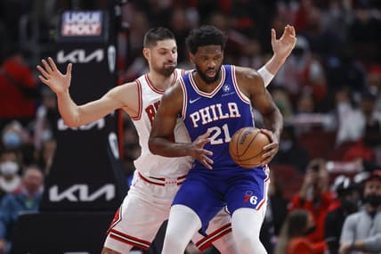 Feb 6, 2022; Chicago, Illinois, USA; Philadelphia 76ers center Joel Embiid (21) is defended by Chicago Bulls center Nikola Vucevic (9) during the first half at United Center. Mandatory Credit: Kamil Krzaczynski-USA TODAY Sports