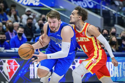 Feb 6, 2022; Dallas, Texas, USA; Dallas Mavericks guard Luka Doncic (77) drives to the basket past Atlanta Hawks guard Trae Young (11) during the first quarter at the American Airlines Center. Mandatory Credit: Jerome Miron-USA TODAY Sports