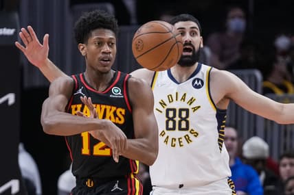 Feb 8, 2022; Atlanta, Georgia, USA; Atlanta Hawks forward De'Andre Hunter (12) passes the ball in front of Indiana Pacers center Goga Bitadze (88) during the first quarter at State Farm Arena. Mandatory Credit: Dale Zanine-USA TODAY Sports