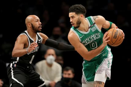 Feb 8, 2022; Brooklyn, New York, USA; Boston Celtics forward Jayson Tatum (0) controls the ball against Brooklyn Nets guard Jevon Carter (0) during the second quarter at Barclays Center. Mandatory Credit: Brad Penner-USA TODAY Sports
