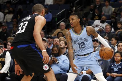 Feb 8, 2022; Memphis, Tennessee, USA; Memphis Grizzlies guard Ja Morant (12) looks for an open lane as Los Angeles Clippers forward Robert Covington (33) defends during the first half at FedExForum. Mandatory Credit: Petre Thomas-USA TODAY Sports