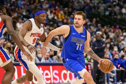 Feb 8, 2022; Dallas, Texas, USA; Detroit Pistons forward Jerami Grant (9) guards Dallas Mavericks guard Luka Doncic (77) during the first quarter at the American Airlines Center. Mandatory Credit: Jerome Miron-USA TODAY Sports