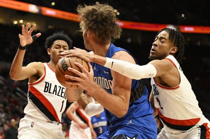 Feb 8, 2022; Portland, Oregon, USA; Portland Trail Blazers forward Trendon Watford (2) and guard Anfernee Simons (1) double team Orlando Magic center Robin Lopez (33) during the first half at Moda Center. Mandatory Credit: Troy Wayrynen-USA TODAY Sports