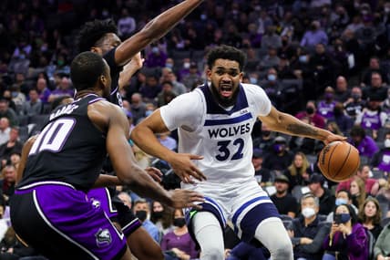 Feb 8, 2022; Sacramento, California, USA; Minnesota Timberwolves center Karl-Anthony Towns (32) drives to the basket against Sacramento Kings center Damian Jones (30) during the second quarter at Golden 1 Center. Mandatory Credit: Sergio Estrada-USA TODAY Sports