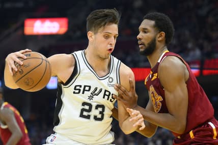 Feb 9, 2022; Cleveland, Ohio, USA; San Antonio Spurs forward Zach Collins (23) dribbles against Cleveland Cavaliers center Evan Mobley (4) in the second quarter at Rocket Mortgage FieldHouse. Mandatory Credit: David Richard-USA TODAY Sports