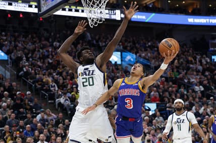 Feb 9, 2022; Salt Lake City, Utah, USA;  Golden State Warriors guard Jordan Poole (3) is fouled by Utah Jazz center Udoka Azubuike (20) while shooting during the first quarter at Vivint Arena. Mandatory Credit: Chris Nicoll-USA TODAY Sports