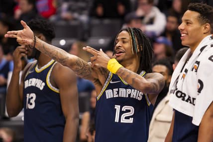 Feb 10, 2022; Detroit, Michigan, USA; Memphis Grizzlies guard Ja Morant (12) celebrates from the bench during the fourth quarter against the Detroit Pistons at Little Caesars Arena. Mandatory Credit: Raj Mehta-USA TODAY Sports