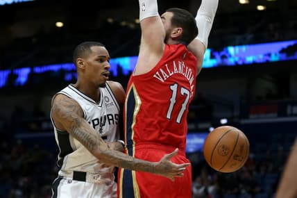 Feb 12, 2022; New Orleans, Louisiana, USA; San Antonio Spurs guard Dejounte Murray (5) passes around New Orleans Pelicans center Jonas Valanciunas (17) in the first quarter at the Smoothie King Center. Mandatory Credit: Chuck Cook-USA TODAY Sports