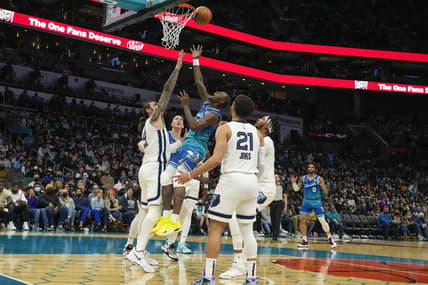 Feb 12, 2022; Charlotte, North Carolina, USA; Charlotte Hornets guard Terry Rozier (3) drives to the basket against Memphis Grizzlies center Steven Adams (4) during the second quarter at the Spectrum Center. Mandatory Credit: Jim Dedmon-USA TODAY Sports