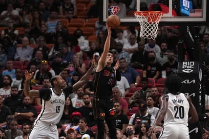 Feb 12, 2022; Miami, Florida, USA; Miami Heat guard Tyler Herro (14) shoots the ball around Brooklyn Nets forward James Johnson (16) during the first half at FTX Arena. Mandatory Credit: Jasen Vinlove-USA TODAY Sports