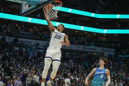Feb 12, 2022; Charlotte, North Carolina, USA; Memphis Grizzlies guard Desmond Bane (22) makes a fast break layup against Charlotte Hornets guard LaMelo Ball (2) during the second half at the Spectrum Center. Mandatory Credit: Jim Dedmon-USA TODAY Sports