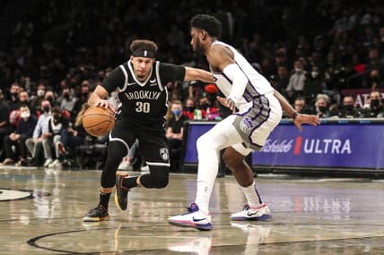 Feb 14, 2022; Brooklyn, New York, USA; Brooklyn Nets guard Seth Curry (30) drives past Sacramento Kings forward Chimezie Metu (7) in the third quarter at Barclays Center. Mandatory Credit: Wendell Cruz-USA TODAY Sports
