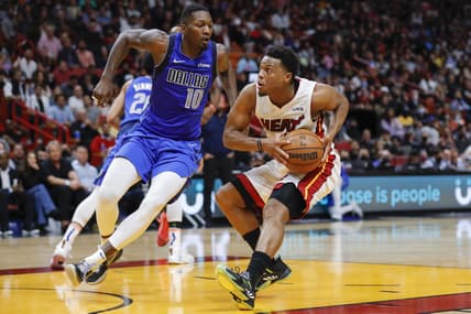 Feb 15, 2022; Miami, Florida, USA; Miami Heat guard Kyle Lowry (7) protects the basketball from Dallas Mavericks forward Dorian Finney-Smith (10) during the fourth quarter at FTX Arena. Mandatory Credit: Sam Navarro-USA TODAY Sports