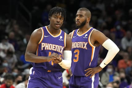 Feb 16, 2022; Phoenix, Arizona, USA; Phoenix Suns guard Aaron Holiday (4) and guard Chris Paul (3) talk during a time-out against the Houston Rockets at Footprint Center. Mandatory Credit: Rick Scuteri-USA TODAY Sports
