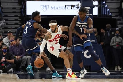 Feb 16, 2022; Minneapolis, Minnesota, USA; Toronto Raptors guard Gary Trent Jr. (33) protects the ball from Minnesota Timberwolves forward Jaden McDaniels (3) and guard Anthony Edwards (1) during the fourth quarter at Target Center. Mandatory Credit: Nick Wosika-USA TODAY Sports