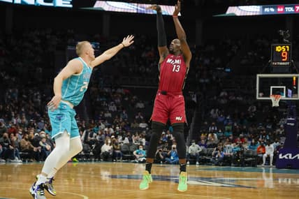 Feb 17, 2022; Charlotte, North Carolina, USA; Miami Heat center Bam Adebayo (13) shoots over Charlotte Hornets center Mason Plumlee (24) during the first quarter at the Spectrum Center. Mandatory Credit: Jim Dedmon-USA TODAY Sports